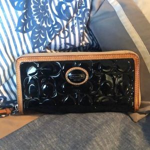 COACH embossed black patent wallet.